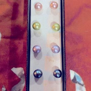Four pairs of multi colored pearl stud earrings